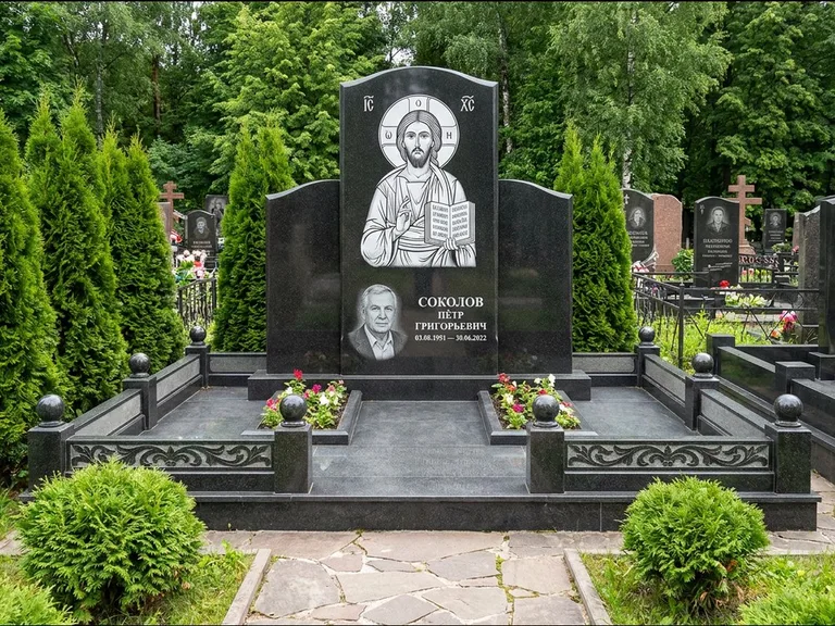 Памятник с гравировкой иконы: широкая горизонтальная лежачая плита-стела — икона в резной рамке-киоте, серая гравийная отсыпка с бордюром, работа «Богданова» в Ярославле