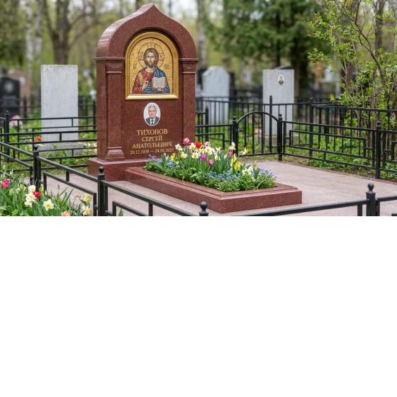 Гранитный памятник в виде раскрытой книги с оградой